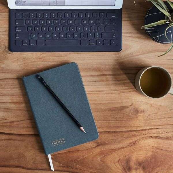 Notebook, pencils, and simple creative tools placed on a clean desk